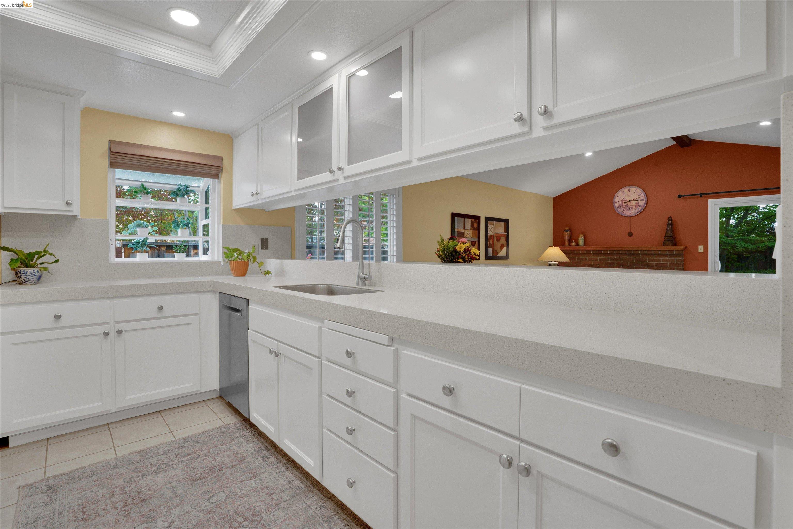 5001 St Garrett Court Concord, CA 94521 - Photo 21 of 45 Kitchen featuring white cabinetry, light-toned countertops, tile flooring, and a stainless steel sink