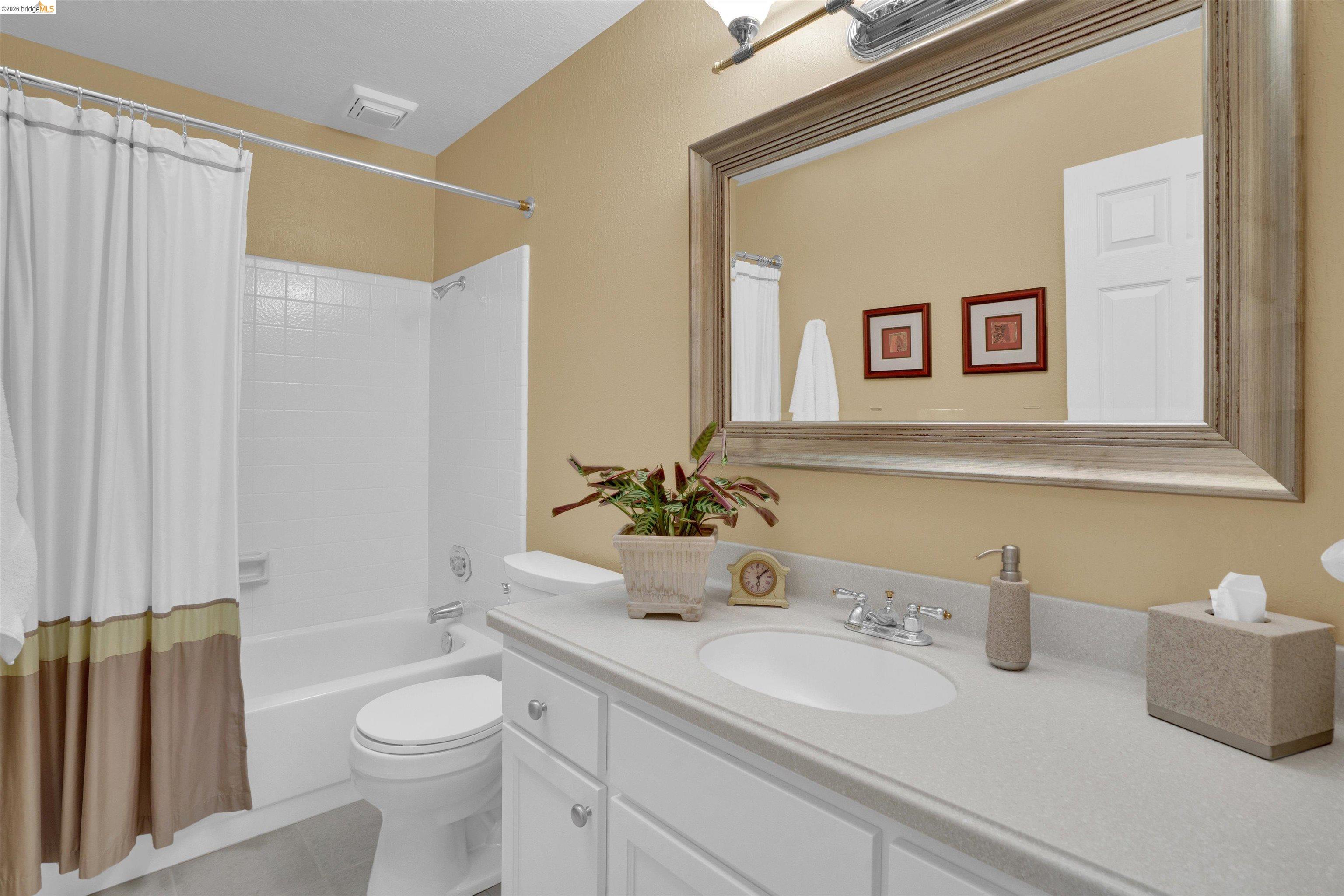 5001 St Garrett Court Concord, CA 94521 - Photo 27 of 45 Bathroom featuring a single vanity with an integrated sink, white cabinetry, and a light-toned countertop