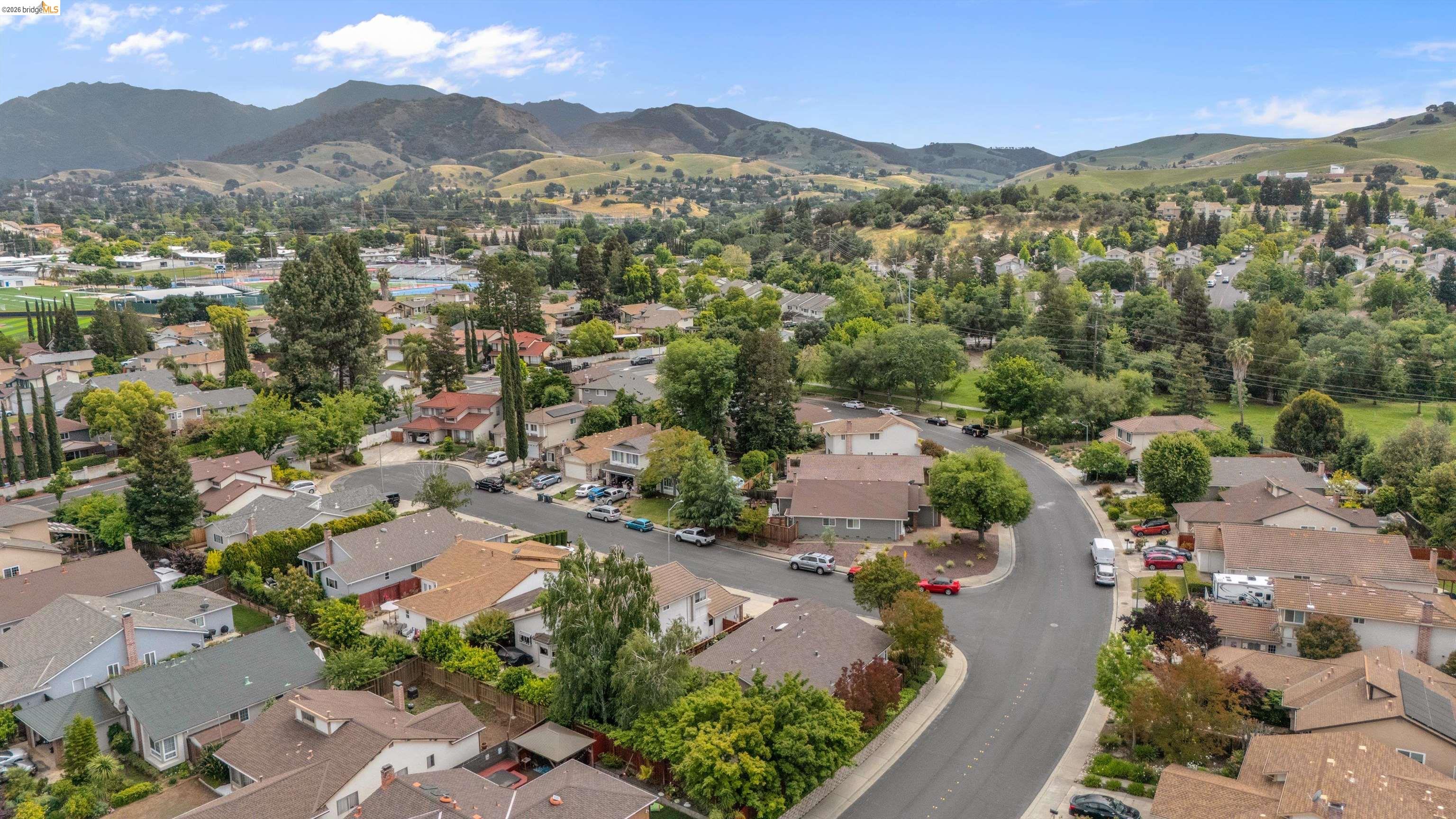 5001 St Garrett Court Concord, CA 94521 - Photo 43 of 45 Residential neighborhood featuring a curved street, mature trees, and a distant mountainous backdrop
