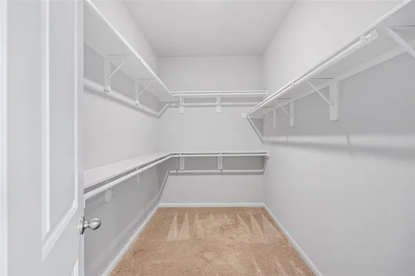 a view of a backyard with a garden and chairs