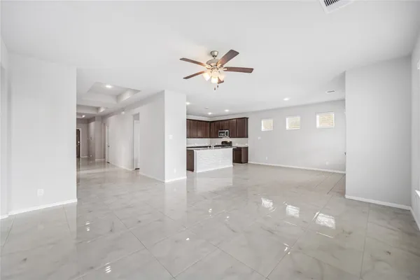 a view of an empty room with a kitchen