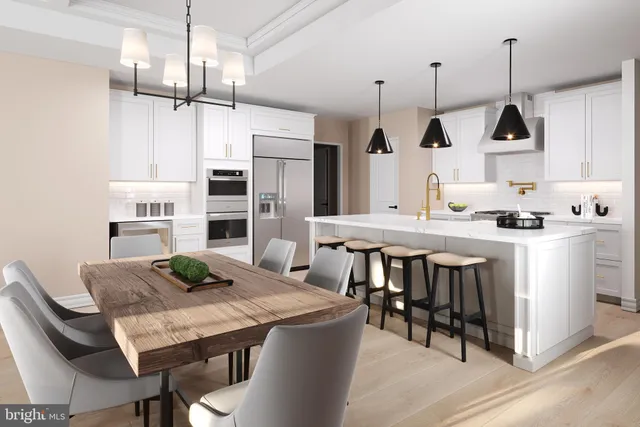 a kitchen with stainless steel appliances kitchen island a table chairs in it and wooden floors