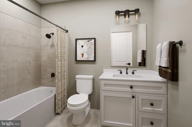 a bathroom with a sink toilet tub and shower