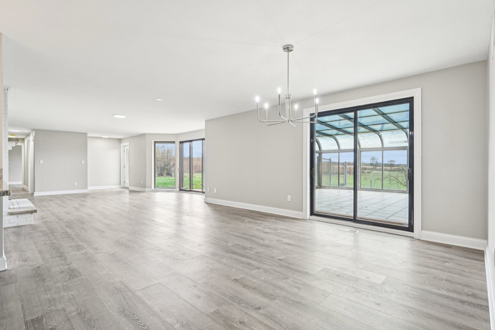 1406 Busse Road Marengo, IL 60152 - Photo 13 of 76 a view of an empty room with wooden floor and a window