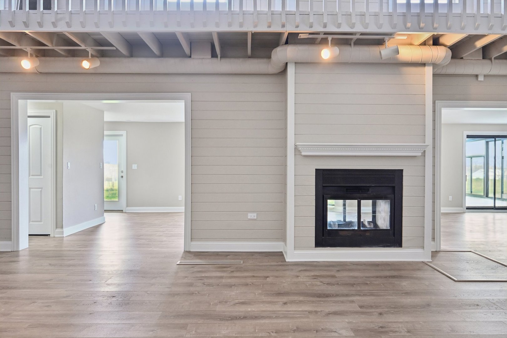1406 Busse Road Marengo, IL 60152 - Photo 16 of 76 a view of an empty room with wooden floor and a fireplace