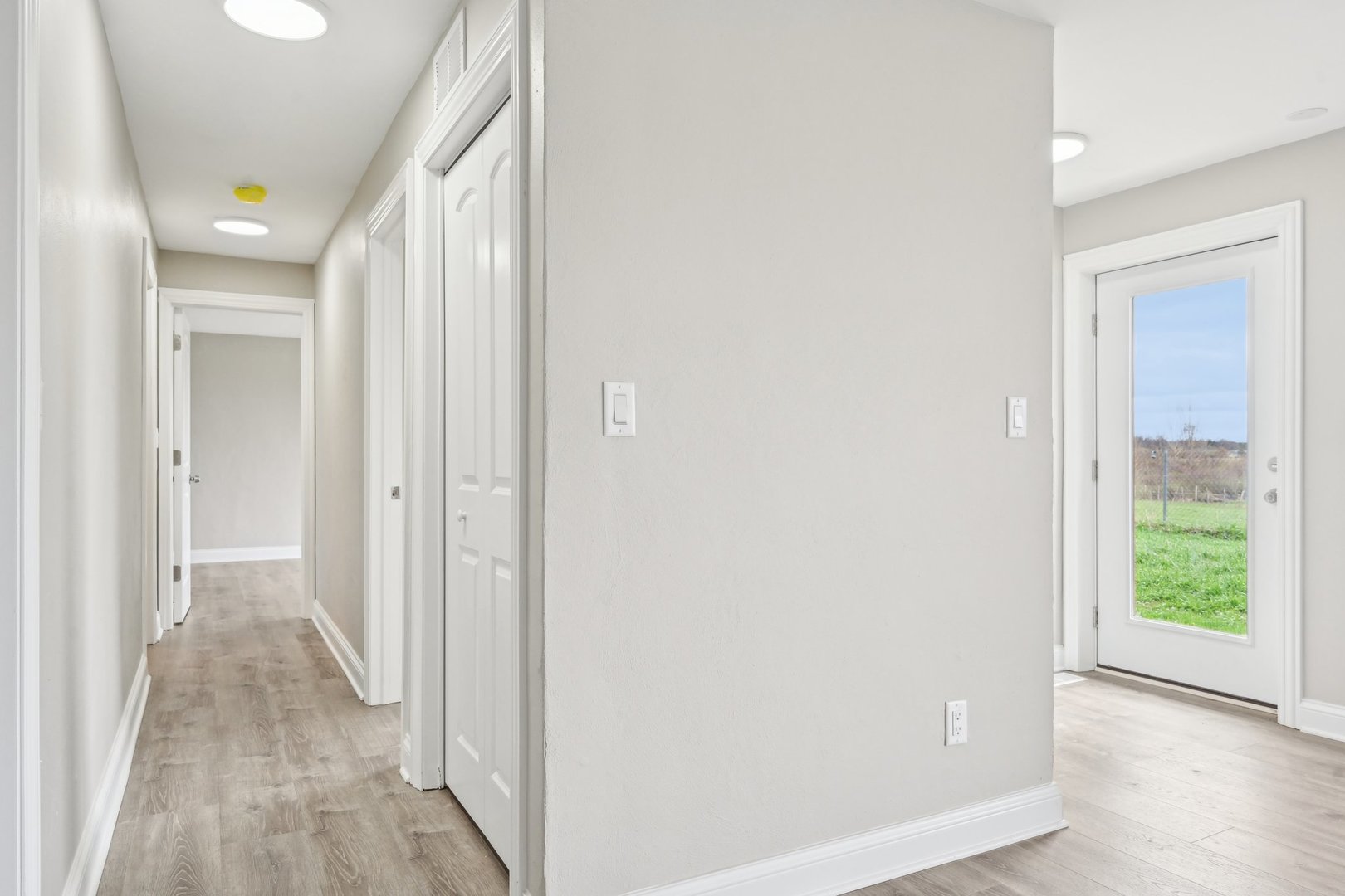 1406 Busse Road Marengo, IL 60152 - Photo 24 of 76 a view of a hallway with wooden floor and a bathroom
