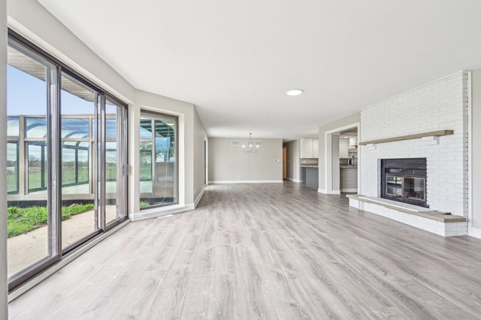1406 Busse Road Marengo, IL 60152 - Photo 3 of 76 a view of empty room with wooden floor and fireplace