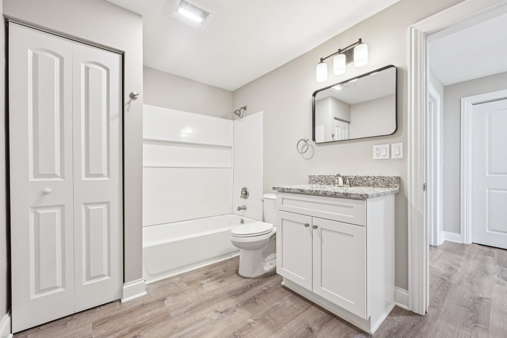 1406 Busse Road Marengo, IL 60152 - Photo 36 of 76 a bathroom with a granite countertop toilet a sink and a mirror