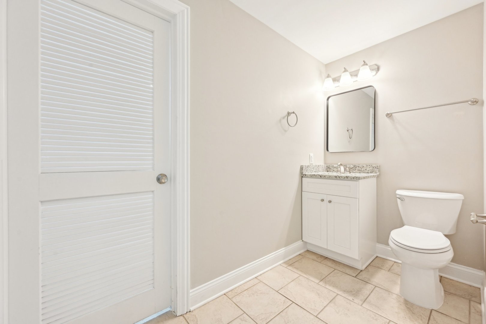 1406 Busse Road Marengo, IL 60152 - Photo 41 of 76 a bathroom with a toilet a sink and mirror