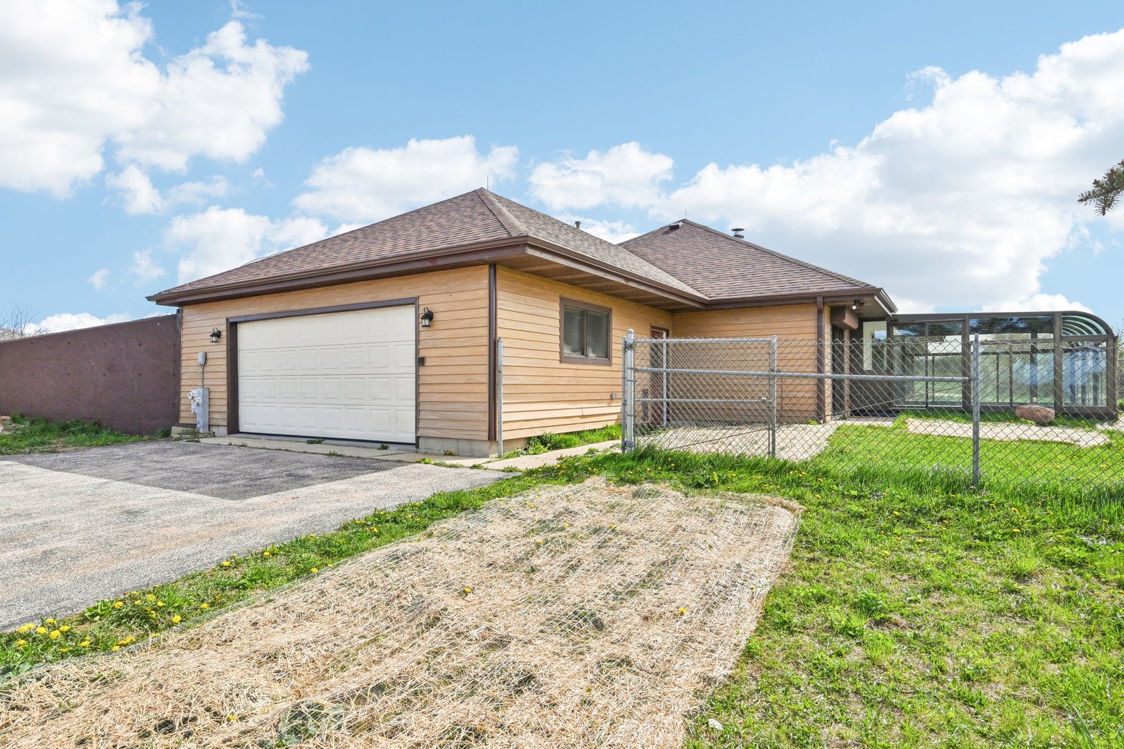 1406 Busse Road Marengo, IL 60152 - Photo 45 of 76 a white house with a small yard and a large parking space