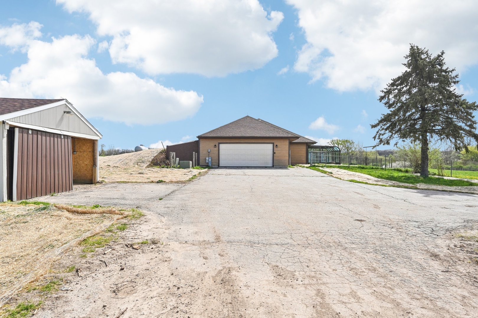1406 Busse Road Marengo, IL 60152 - Photo 47 of 76 a front view of a house with a yard and garage