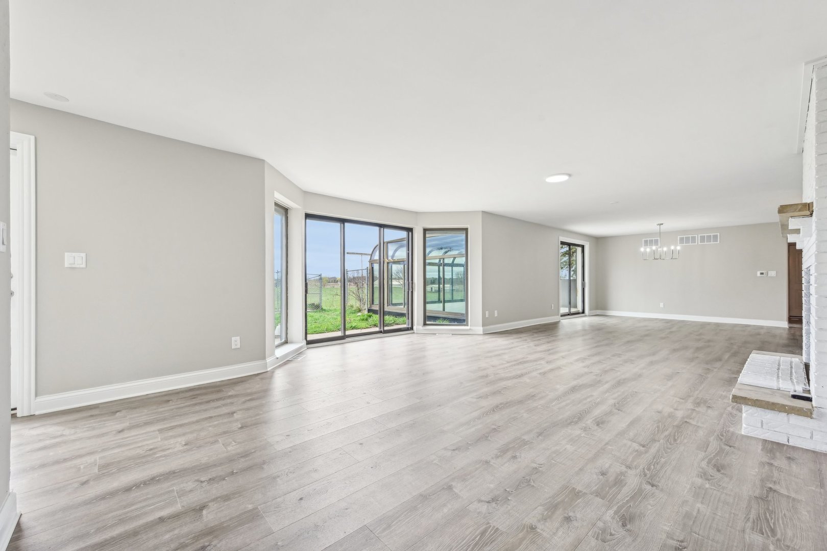 1406 Busse Road Marengo, IL 60152 - Photo 5 of 76 a view of an empty room with wooden floor and a window