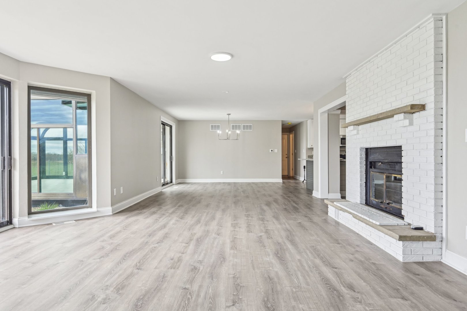 1406 Busse Road Marengo, IL 60152 - Photo 8 of 76 a view of an empty room with wooden floor and a window