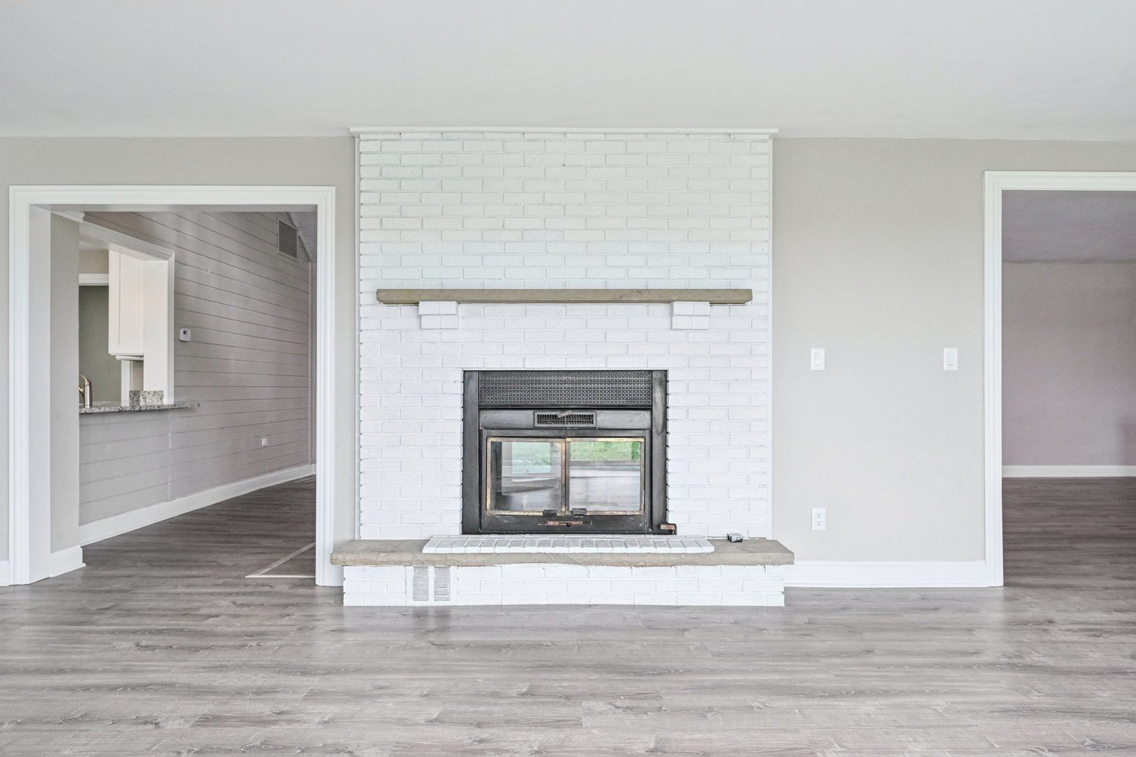 1406 Busse Road Marengo, IL 60152 - Photo 9 of 76 a living room with a fireplace and a wooden floor