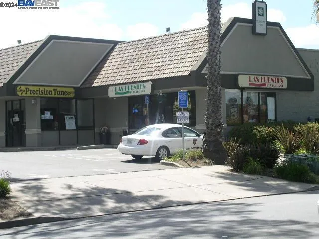 a car parked in front of white house
