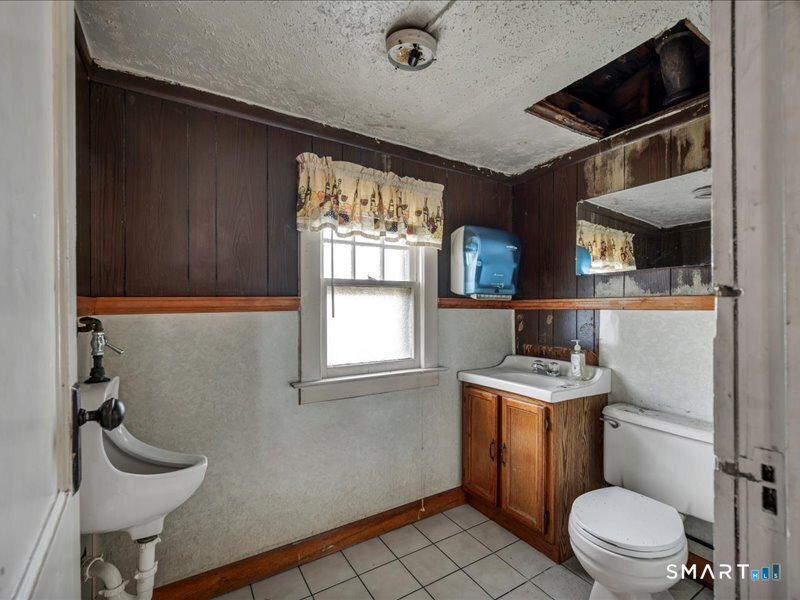 61 Maple Avenue Wallingford, CT 06492 - Photo 5 of 20 a bathroom with a toilet a sink and a window