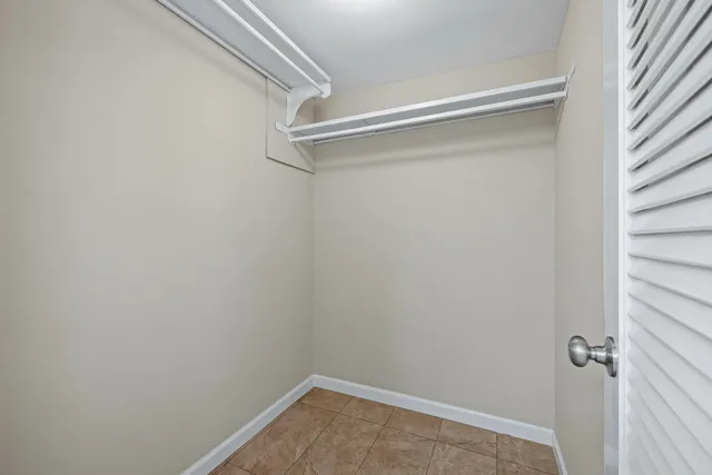 a view of balcony with a large window and palm tree