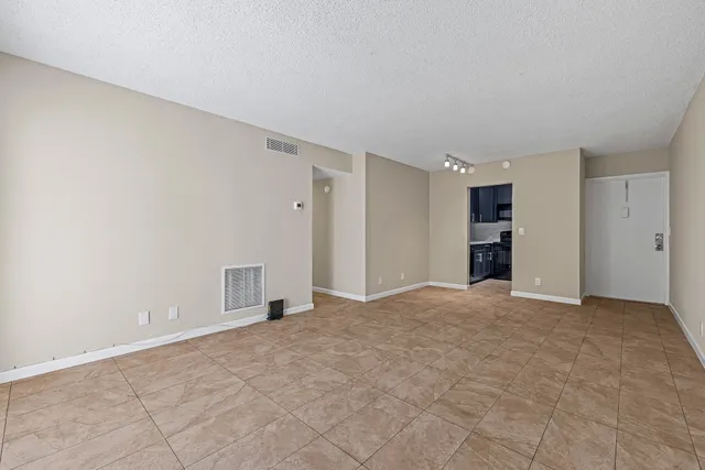 a view of an empty room with a closet