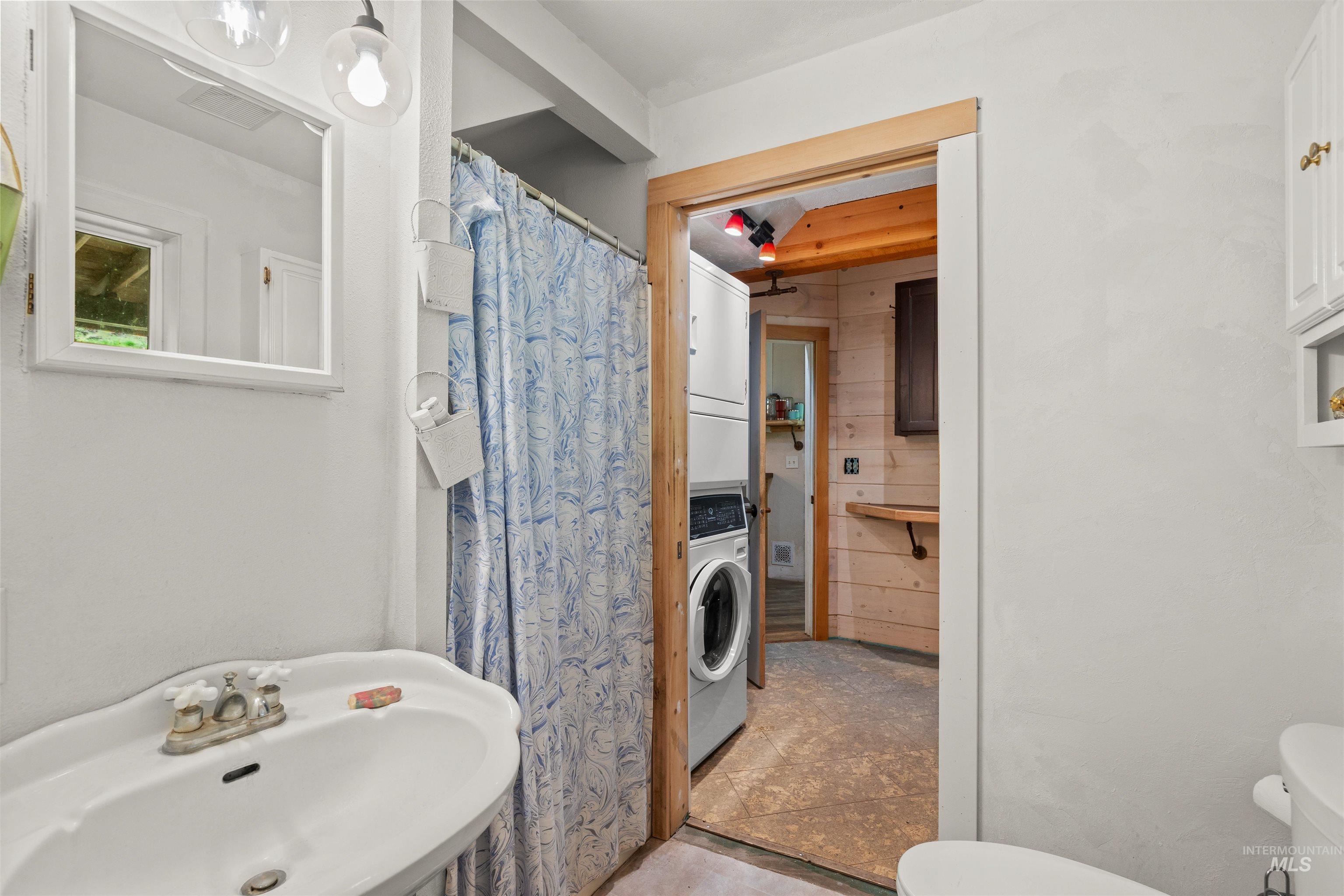 1314 Cedar Ridge Road Kendrick, ID 83537 - Photo 15 of 50 White pedestal sink with a framed mirror and globe light fixture