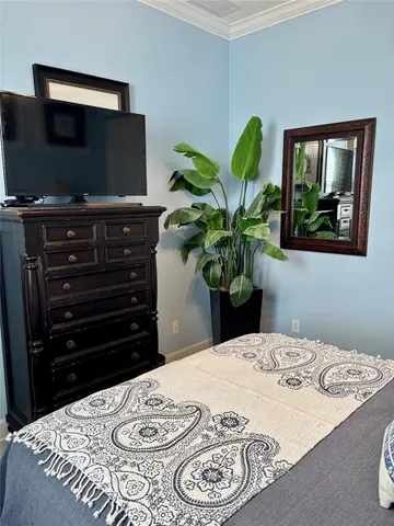 a bedroom with a bed and a television