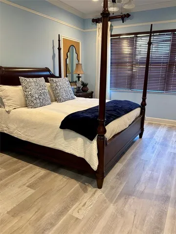 a bedroom with a large bed and a window