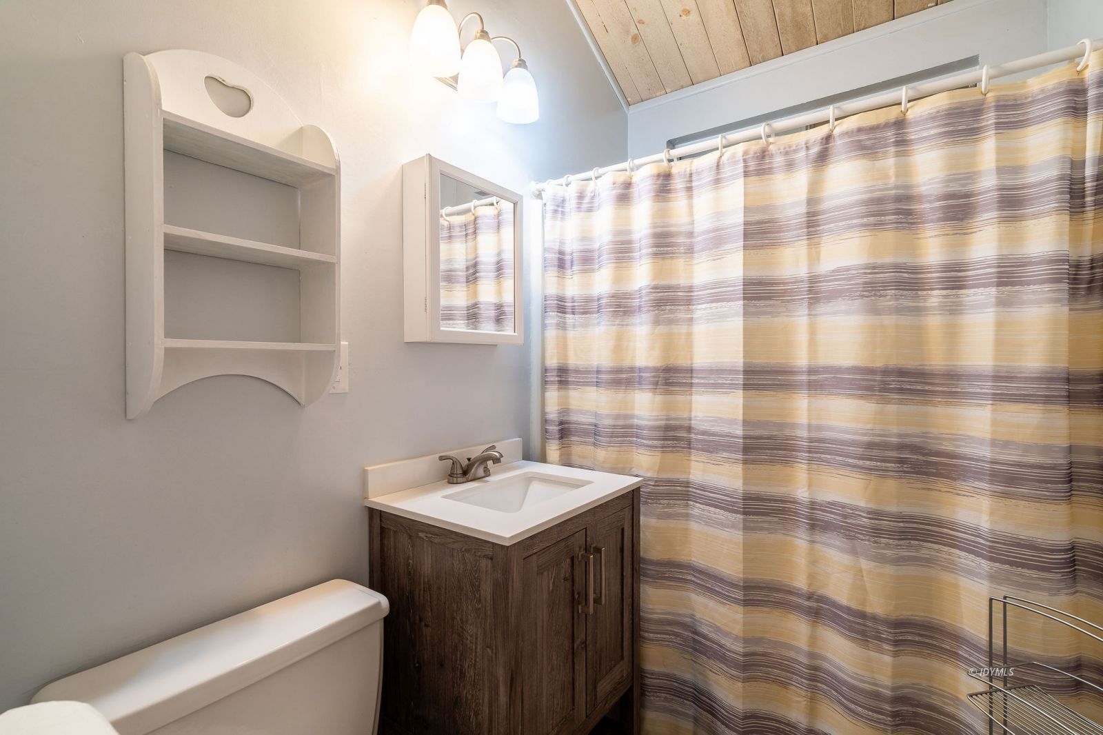 59341 Courtesy Drive Mountain Center, CA 92561 - Photo 29 of 49 a bathroom with a sink a toilet and shower curtain
