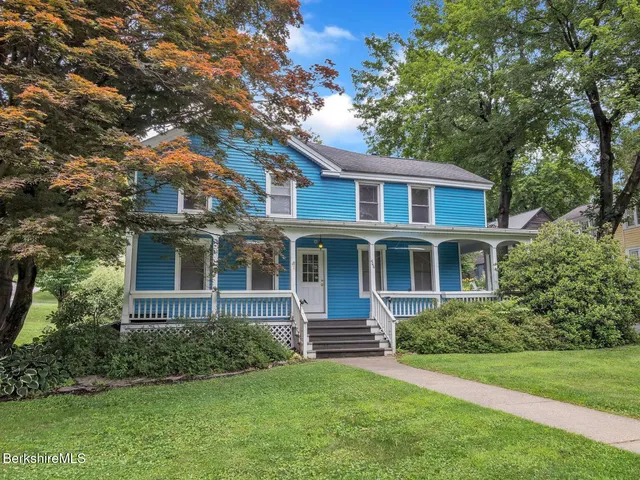 a front view of a house with a garden
