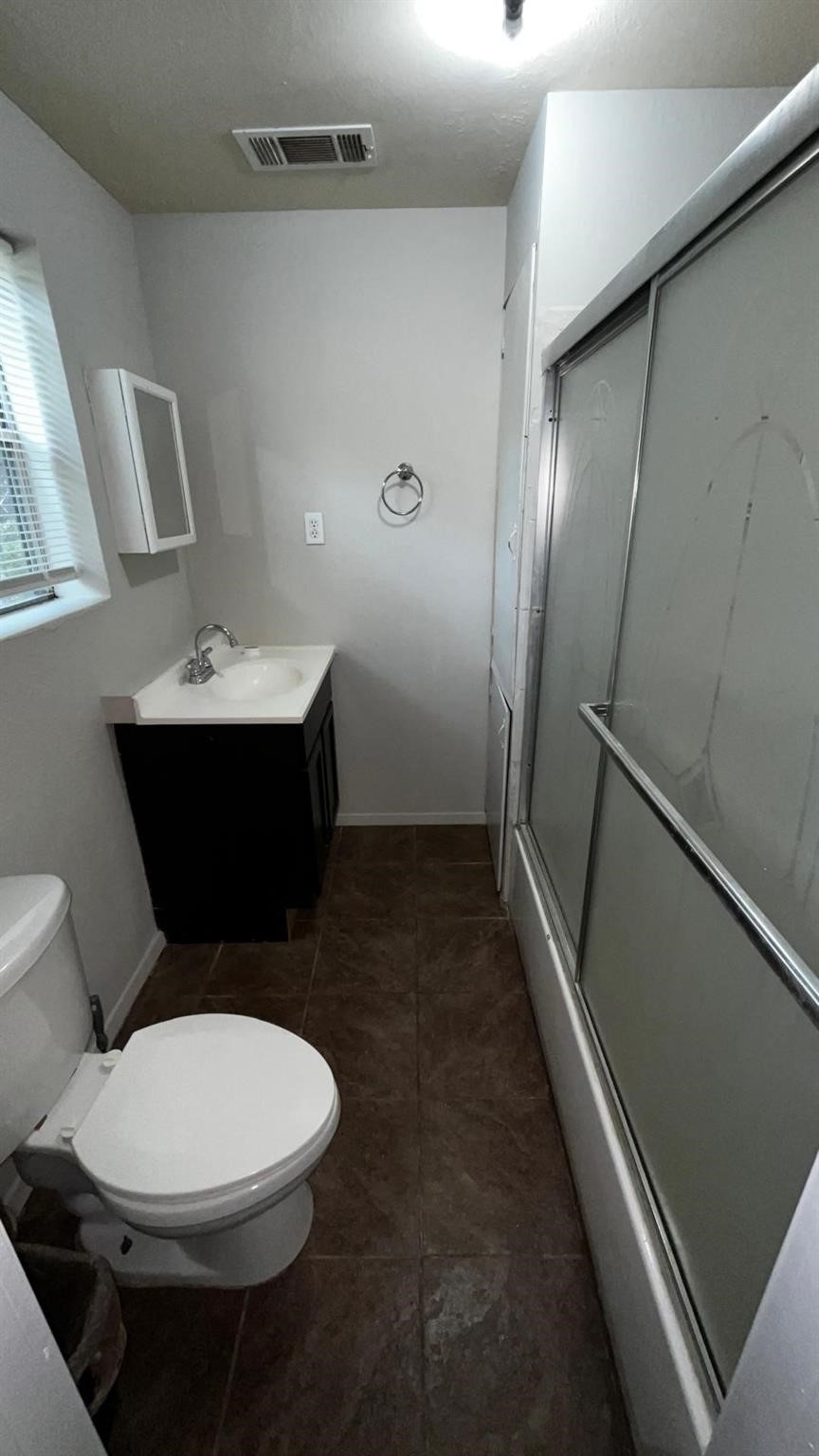 221 East Lobit Avenue, Unit A Baytown, TX 77520 - Photo 4 of 6 a bathroom with a toilet sink and mirror