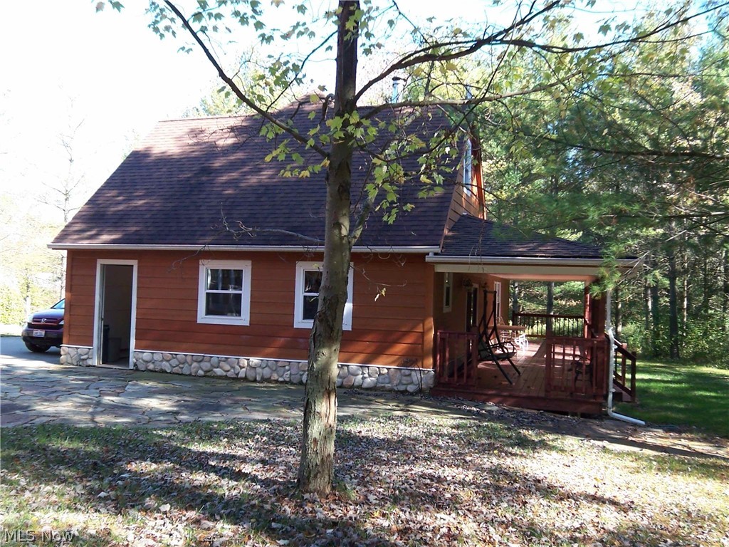 14543 Ensign Road Burton, OH 44021 - Photo 29 of 32 Side view of the garage with a covered deck on the back.
