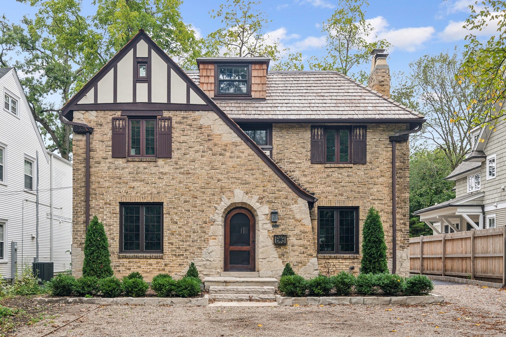 a front view of a house with plants