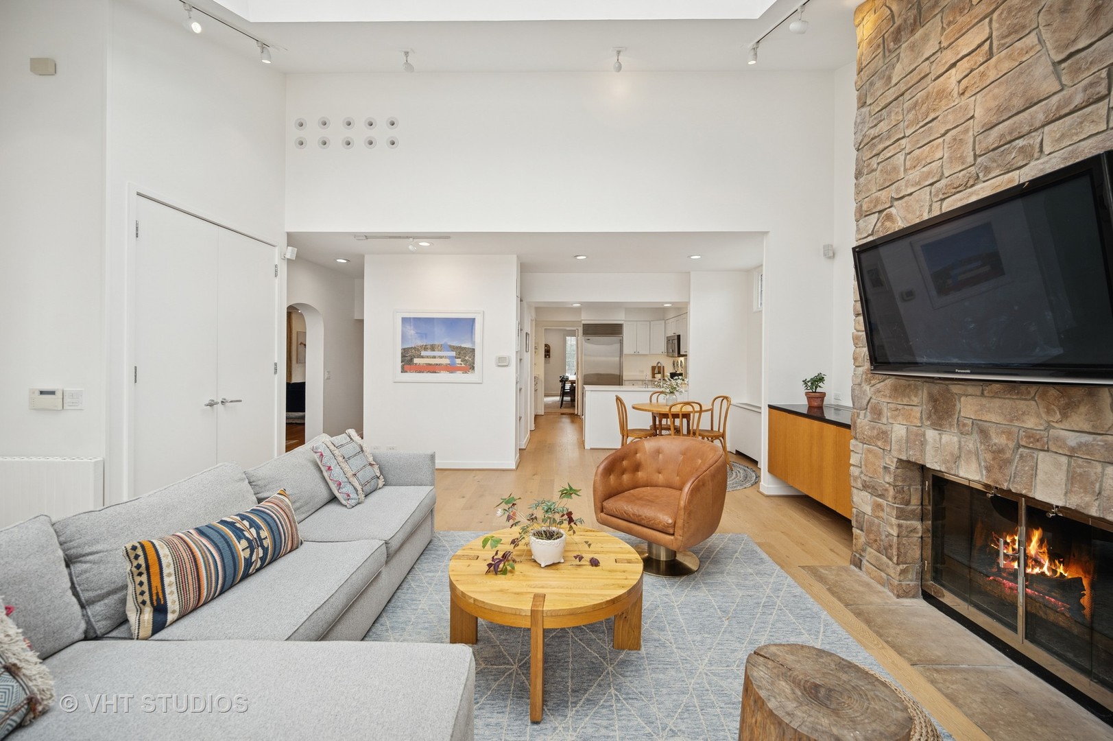 1413 Tower Road Winnetka, IL 60093 - Photo 13 of 32 a living room with furniture a fireplace and a flat screen tv