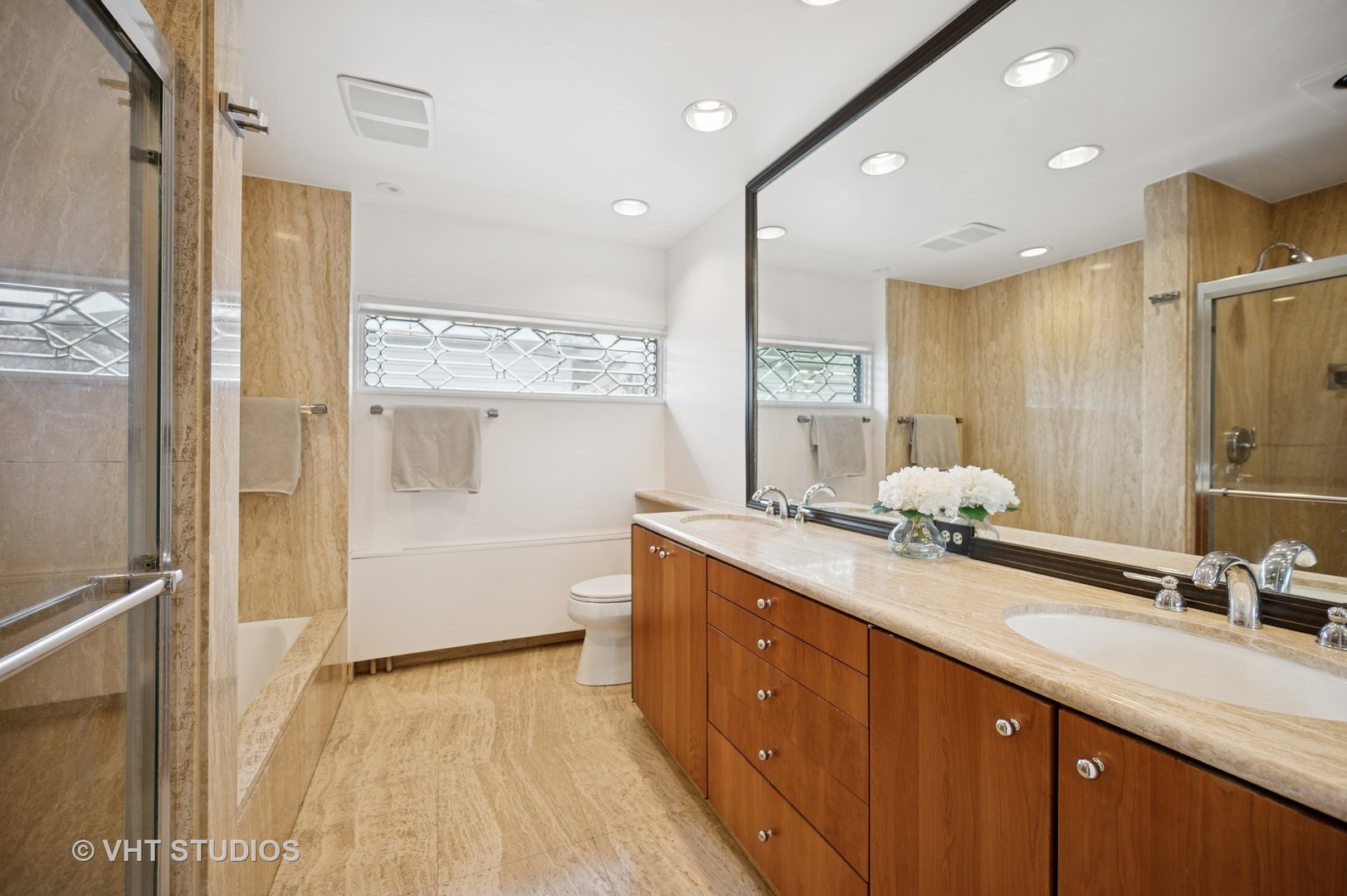 1413 Tower Road Winnetka, IL 60093 - Photo 17 of 32 a bathroom with a double vanity sink a mirror and a shower