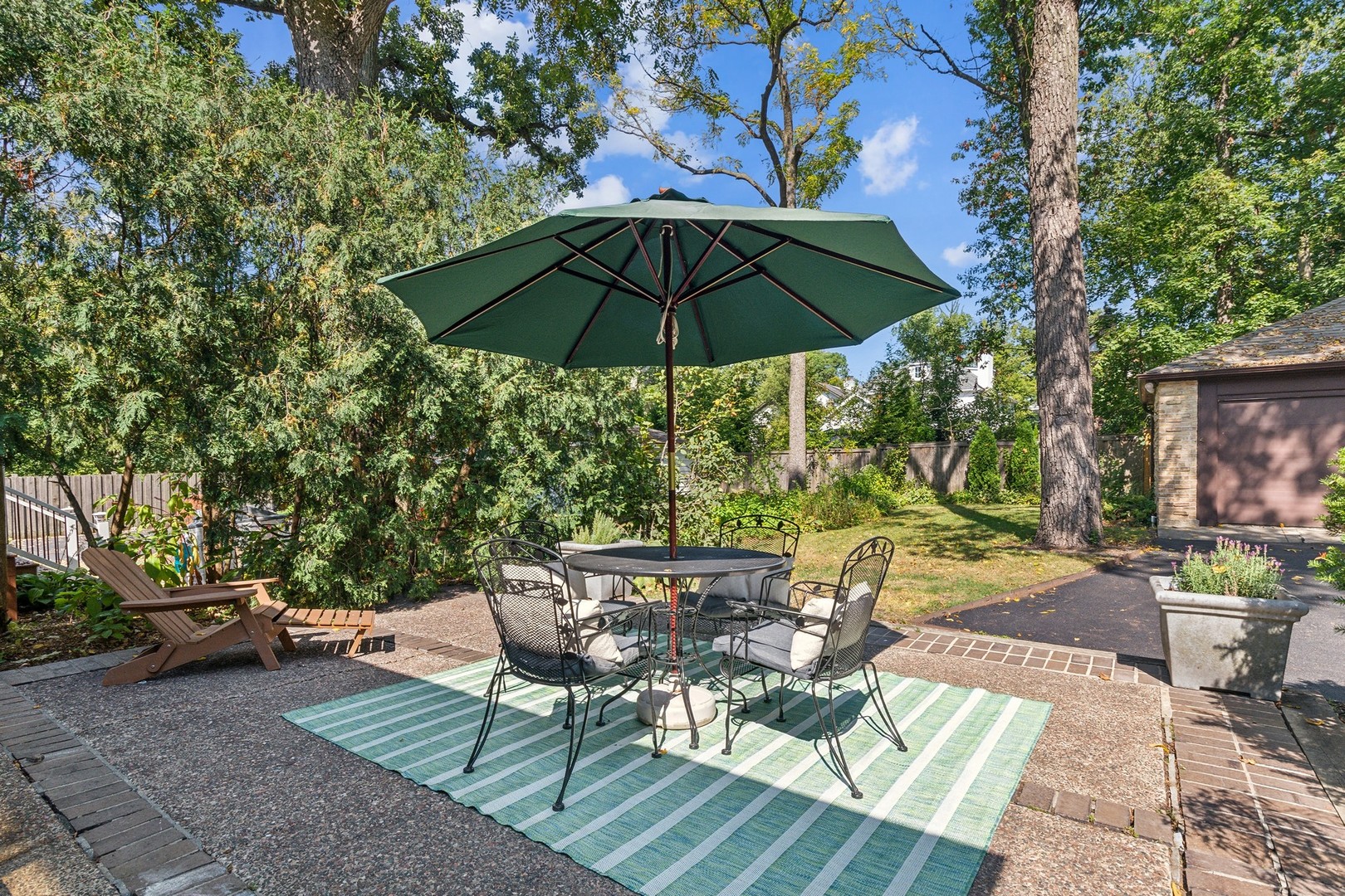 1413 Tower Road Winnetka, IL 60093 - Photo 25 of 32 a view of a patio with table and chairs under an umbrella