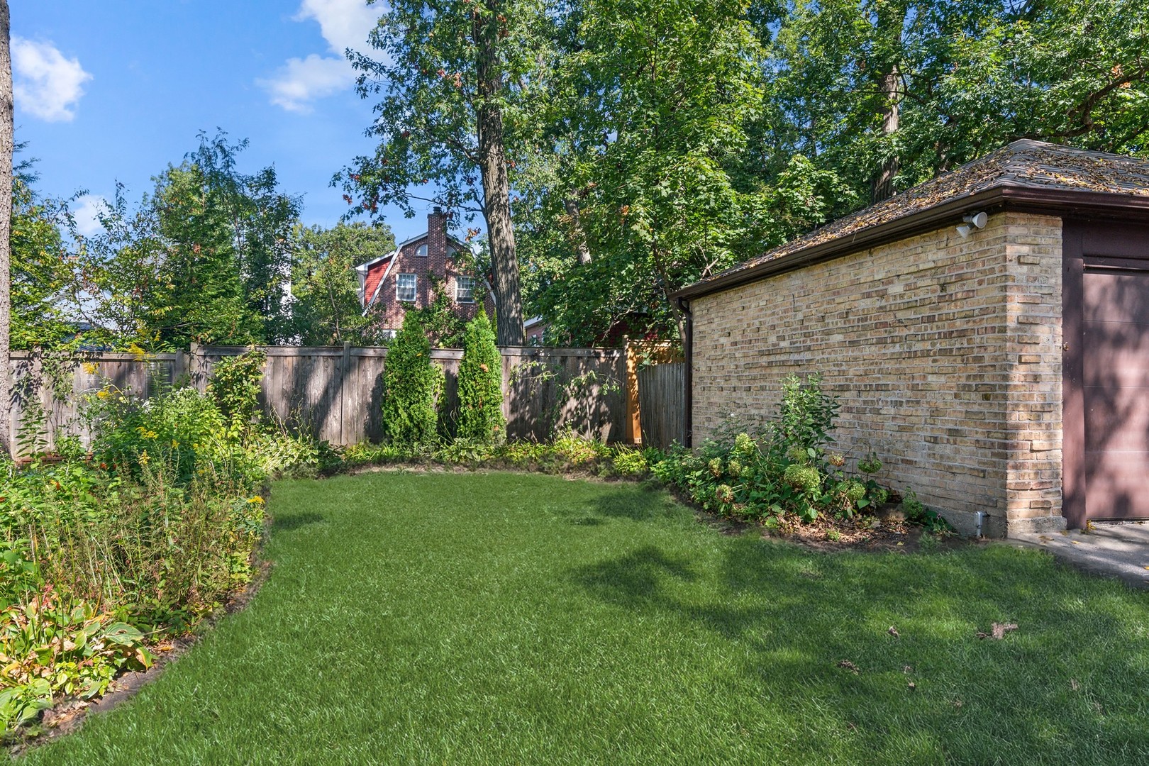 1413 Tower Road Winnetka, IL 60093 - Photo 26 of 32 a backyard of a house with plants and large tree