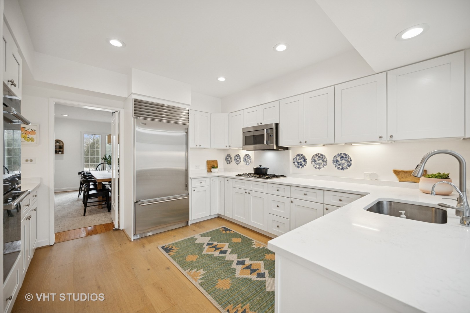 1413 Tower Road Winnetka, IL 60093 - Photo 8 of 32 a kitchen with white cabinets and stainless steel appliances