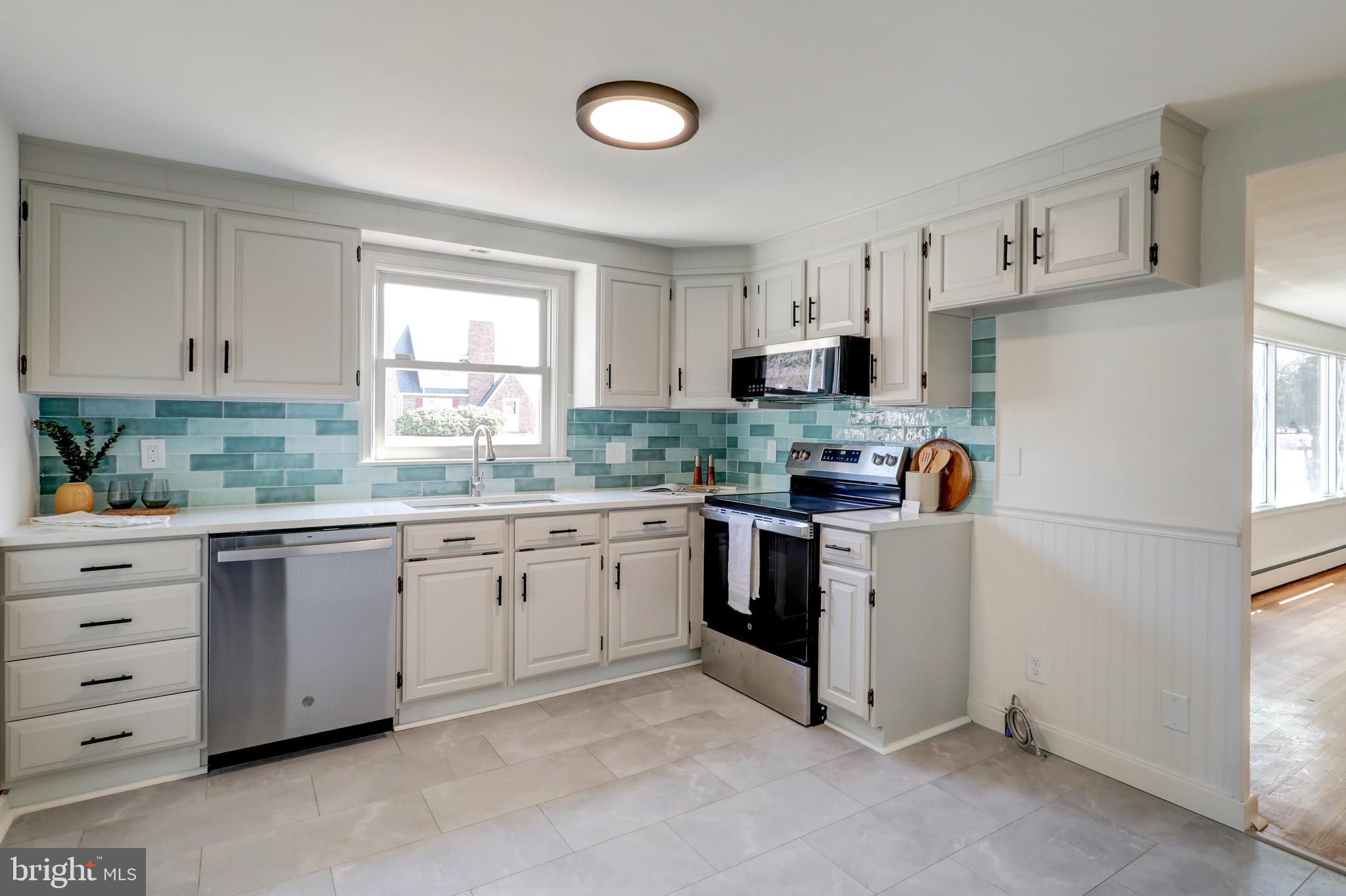421 Edgehill Road York, PA 17403 - Photo 7 of 44 a kitchen with granite countertop white cabinets and white appliances
