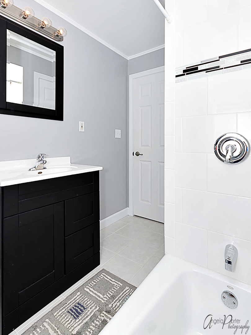 135 Eagle Point Road Fox Lake, IL 60020 - Photo 18 of 27 a bathroom with a tub sink and mirror