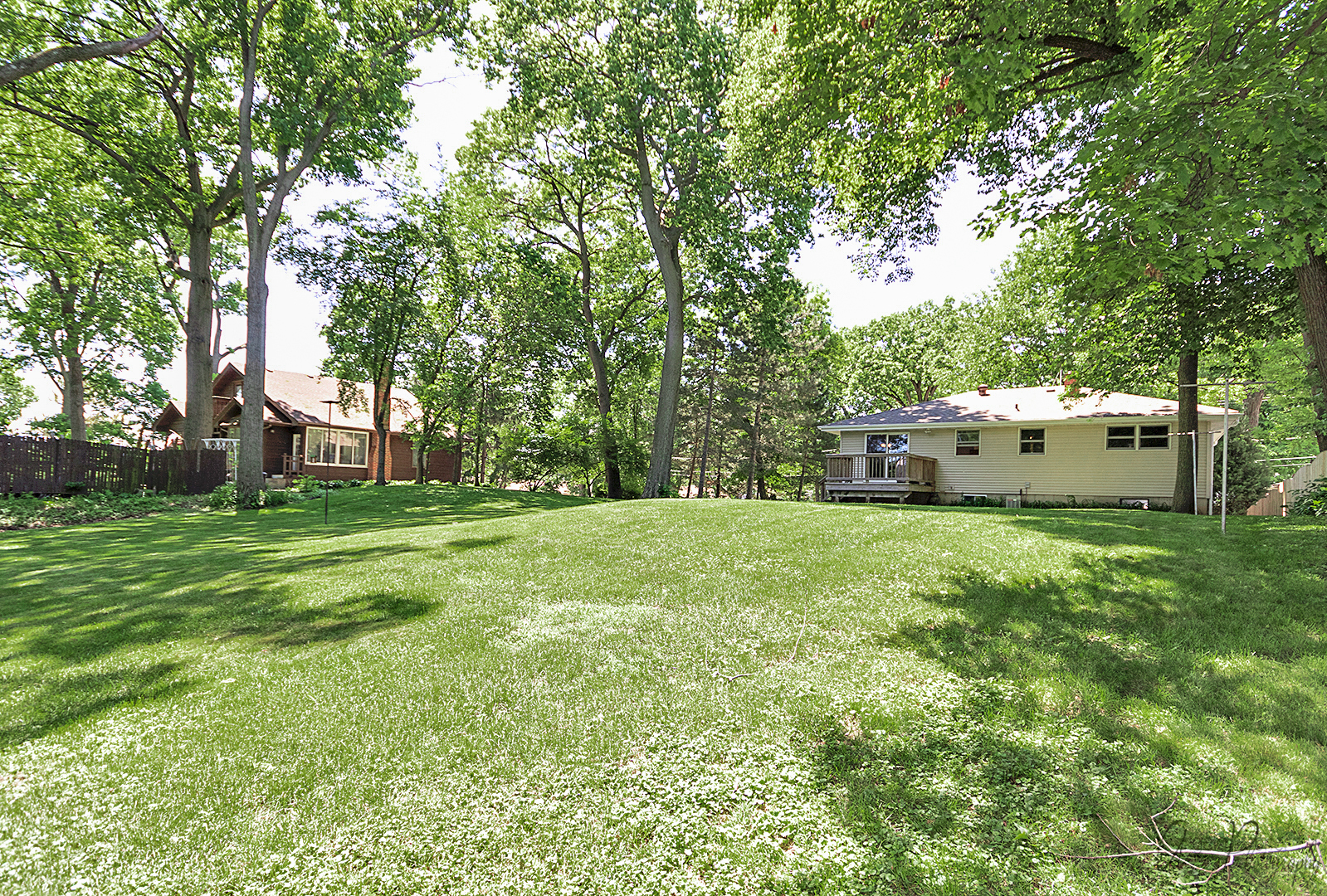 135 Eagle Point Road Fox Lake, IL 60020 - Photo 25 of 27 a view of a white house in front of a big yard with large trees