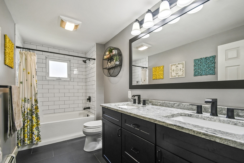 293 Harrington Way Worcester, MA 01604 - Photo 11 of 29 a bathroom with a double vanity sink toilet and shower