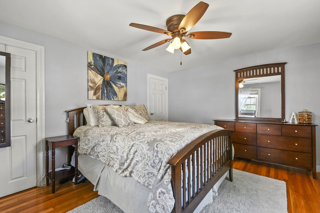 293 Harrington Way Worcester, MA 01604 - Photo 13 of 29 a bedroom with a bed and a chandelier