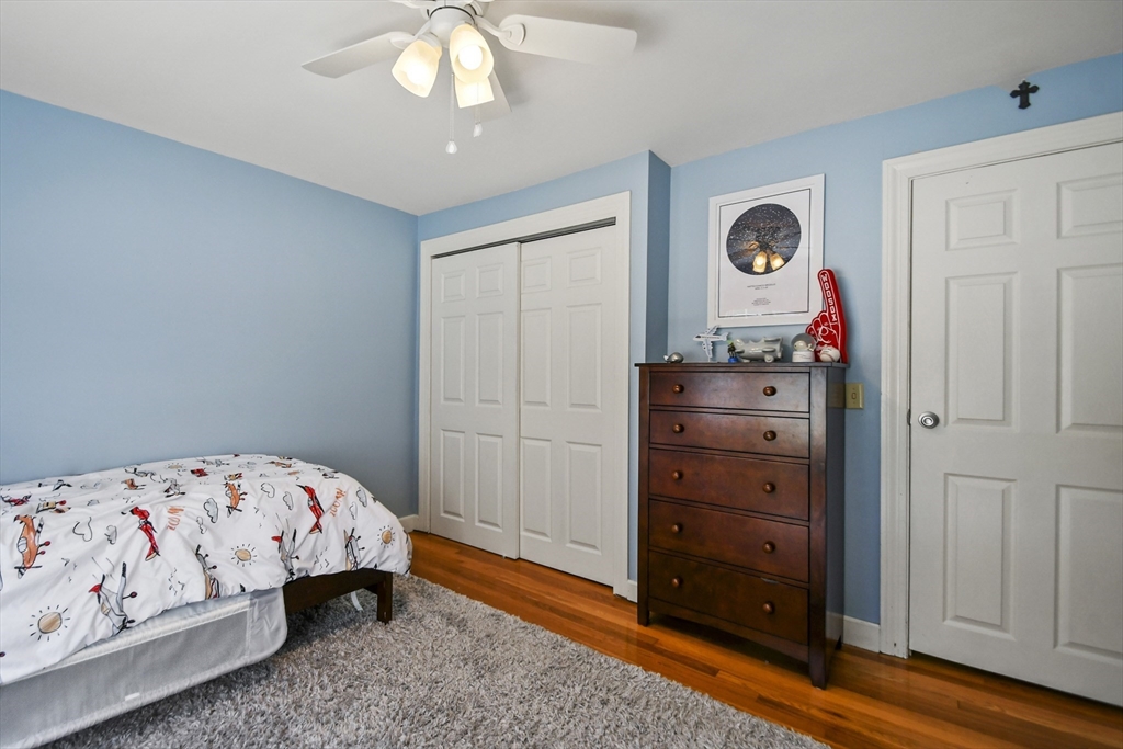 293 Harrington Way Worcester, MA 01604 - Photo 17 of 29 a bedroom with a bed and a mirror on dresser