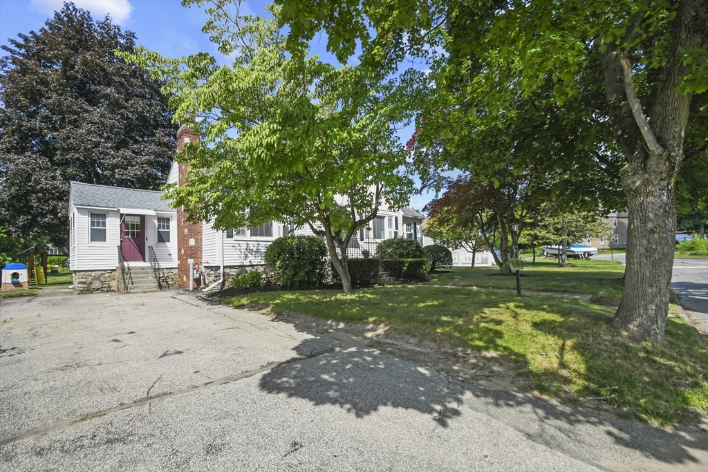 293 Harrington Way Worcester, MA 01604 - Photo 25 of 29 a view of a house with a tree in front of it