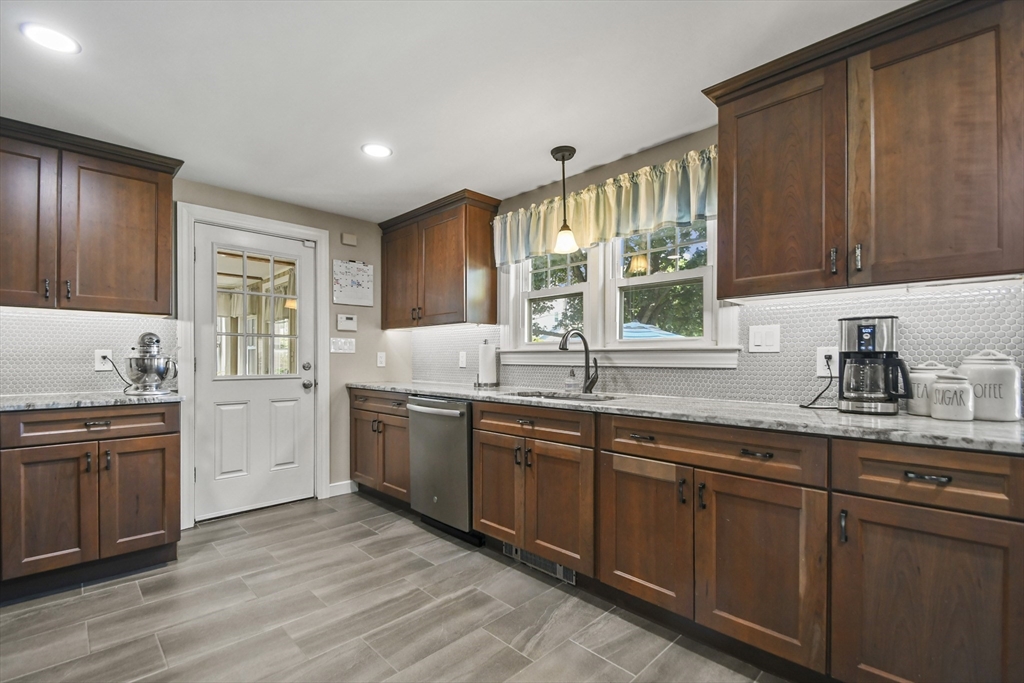 293 Harrington Way Worcester, MA 01604 - Photo 6 of 29 a kitchen with sink stove and cabinets