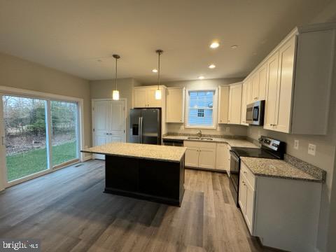 1095 Llano Drive La Plata, MD 20646 - Photo 12 of 19 a large kitchen with kitchen island a large counter top space a sink stainless steel appliances and cabinets