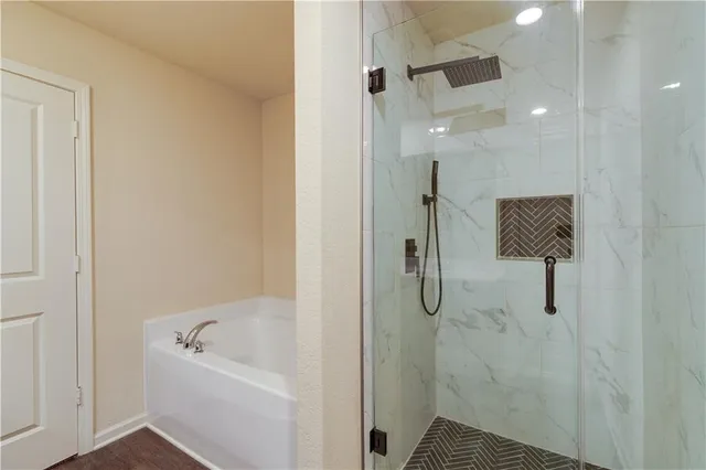 a bathroom with a bathtub and shower