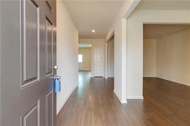 a view of hallway with wooden floor