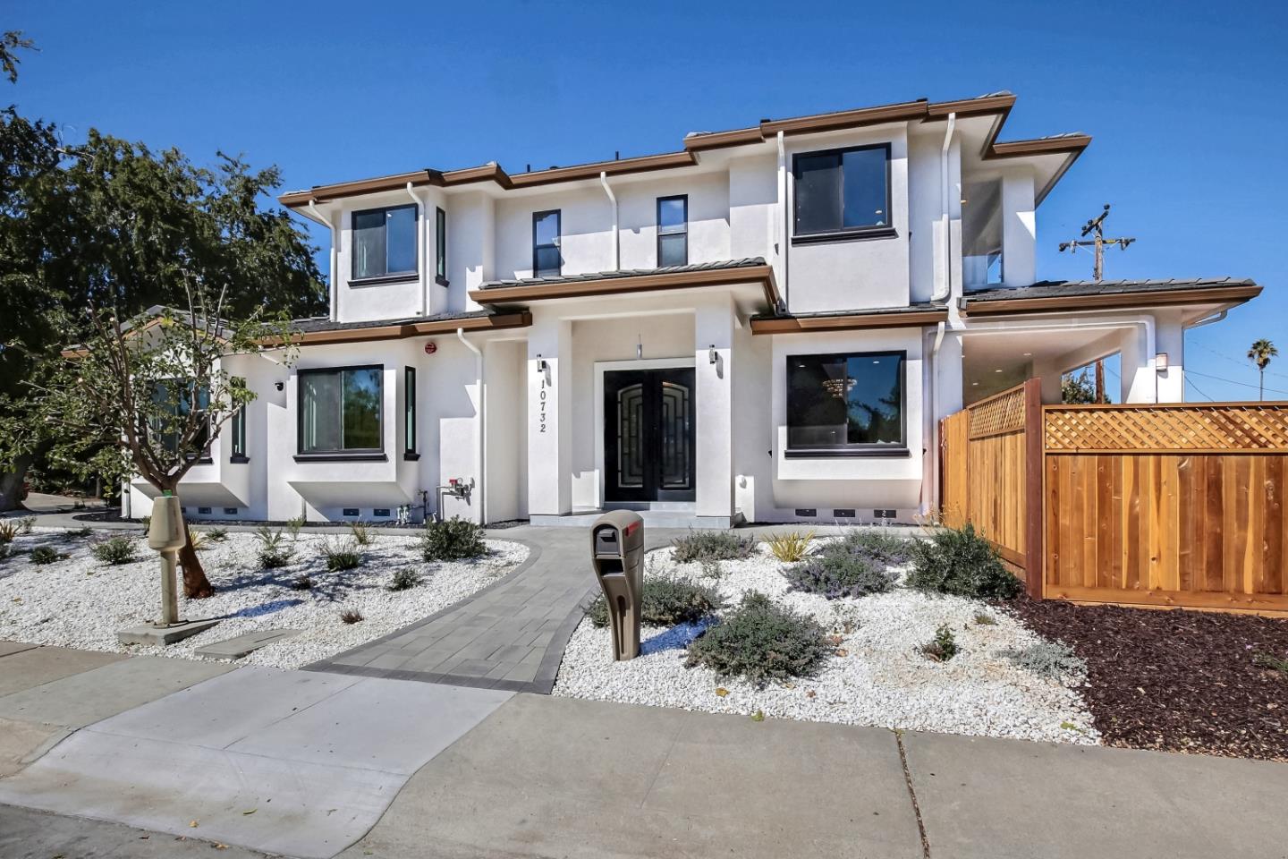 a front view of a house with outdoor seating