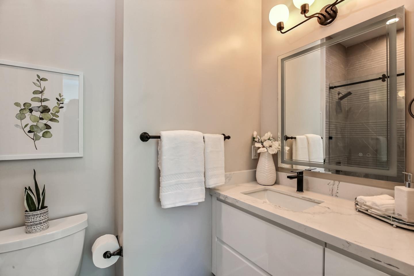 10732 Culbertson Drive Cupertino, CA 95014 - Photo 20 of 36 a bathroom with a granite countertop sink and a mirror