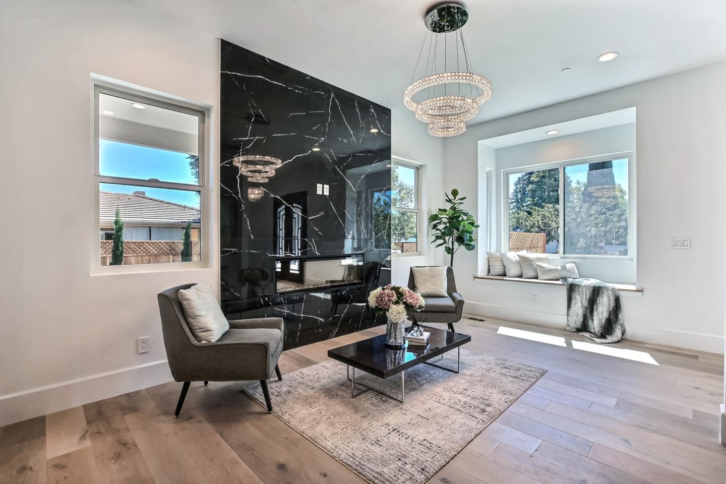 10732 Culbertson Drive Cupertino, CA 95014 - Photo 3 of 36 a living room with furniture a chandelier and a large window