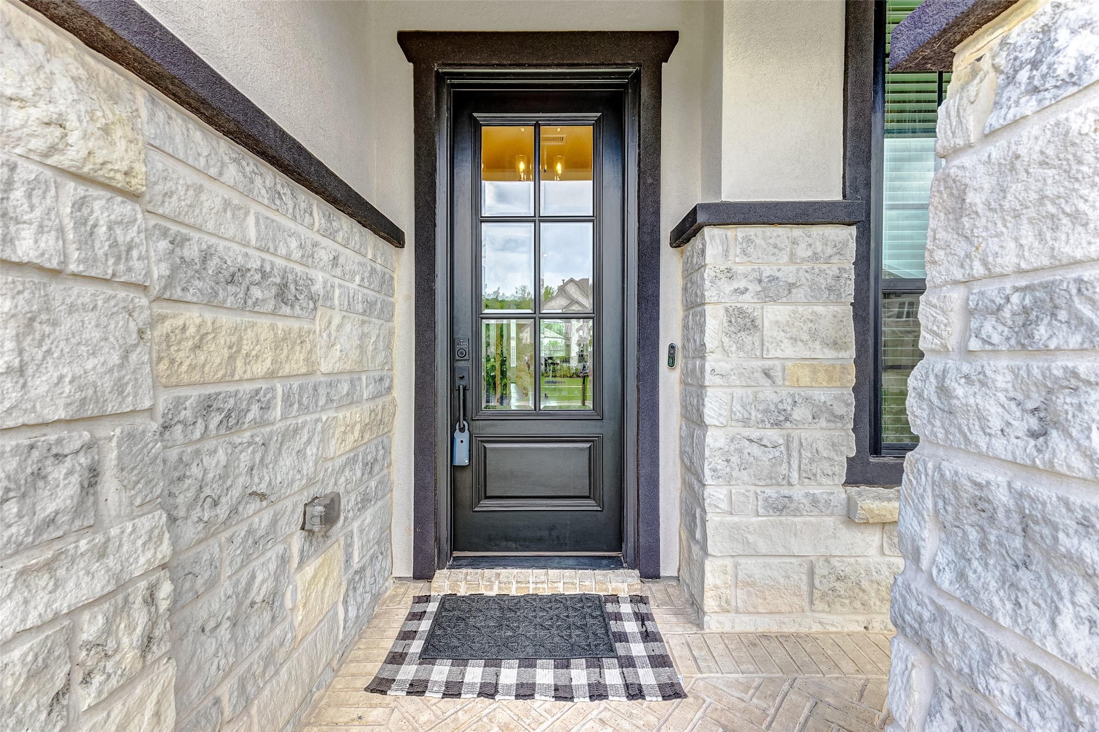 5318 Streamside Trail Fulshear, TX 77441 - Photo 7 of 43 As you approach the home, a charming covered front porch beckons, offering a warm welcome to guests. An elegant 8-foot wooden door, with large glass panels, offers a glimpse of the sophistication that lies beyond.